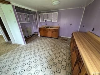 kitchen featuring sink and light tile flooring