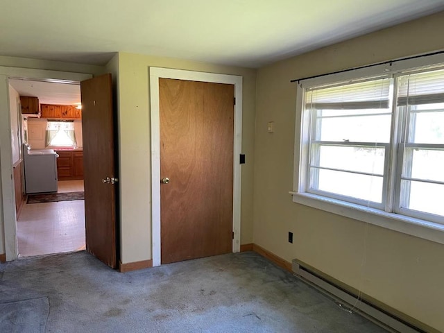 unfurnished bedroom featuring a closet, carpet, and baseboard heating