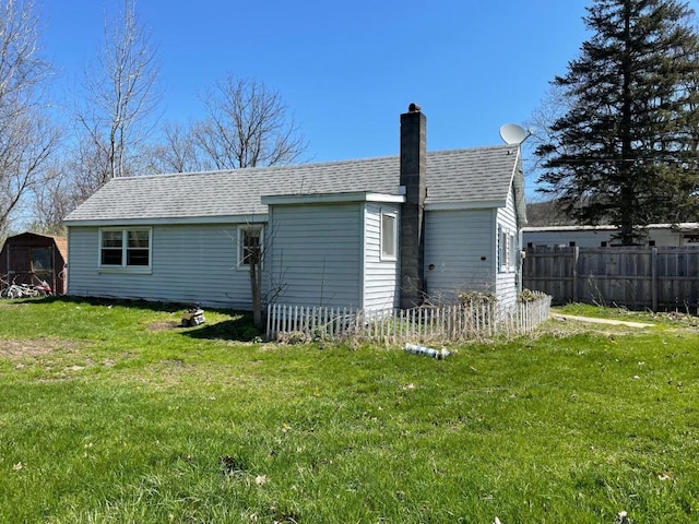 rear view of house with a yard