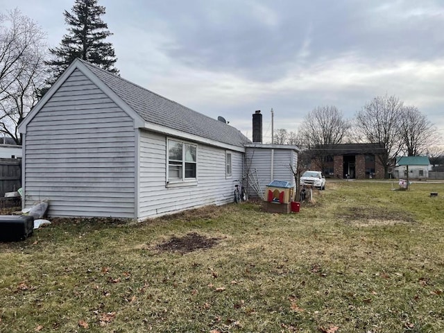 view of side of property with a yard