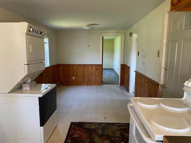 interior space featuring tile flooring, dual sinks, and stacked washer / drying machine