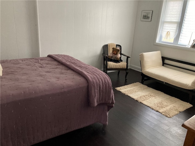 bedroom with dark wood-type flooring