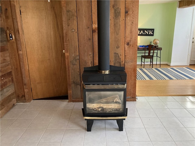 interior details with a wood stove and tile patterned flooring