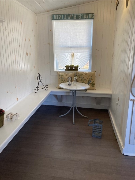 bathroom featuring lofted ceiling, wood walls, hardwood / wood-style floors, and breakfast area