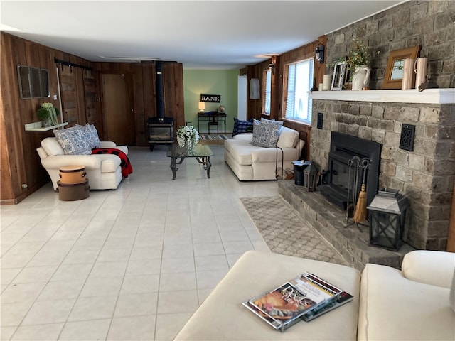 tiled living room featuring a fireplace and wood walls