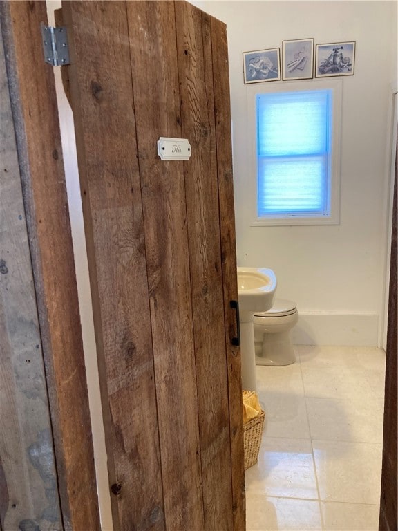 bathroom featuring toilet and tile patterned floors