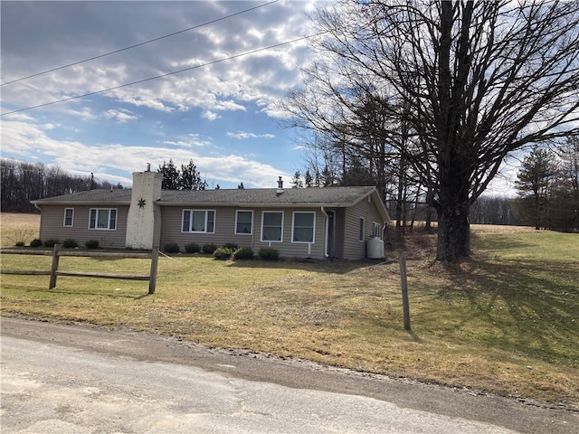 ranch-style home with a front lawn