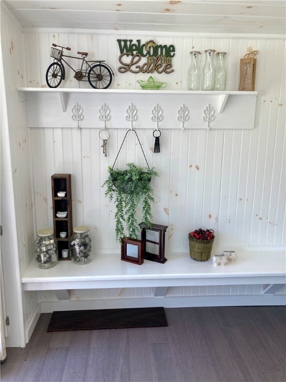 mudroom with wood-type flooring and wood walls