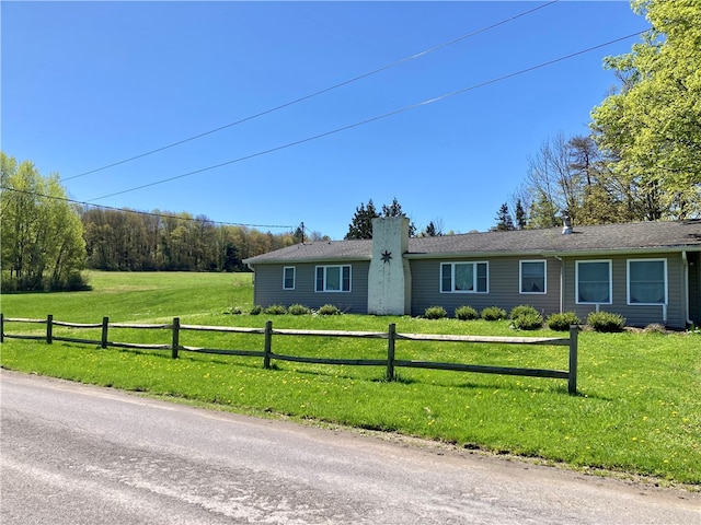 ranch-style home with a front lawn