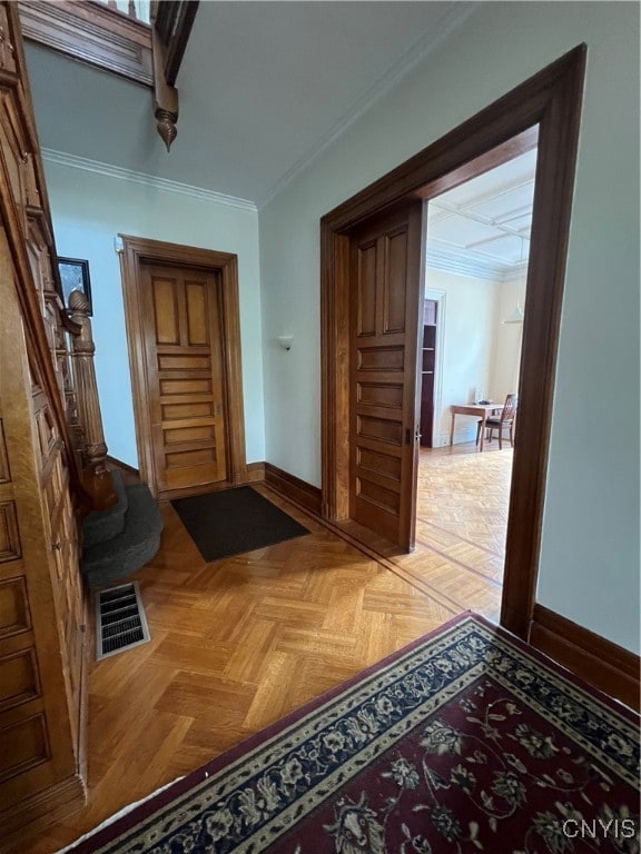 corridor featuring light parquet floors and crown molding