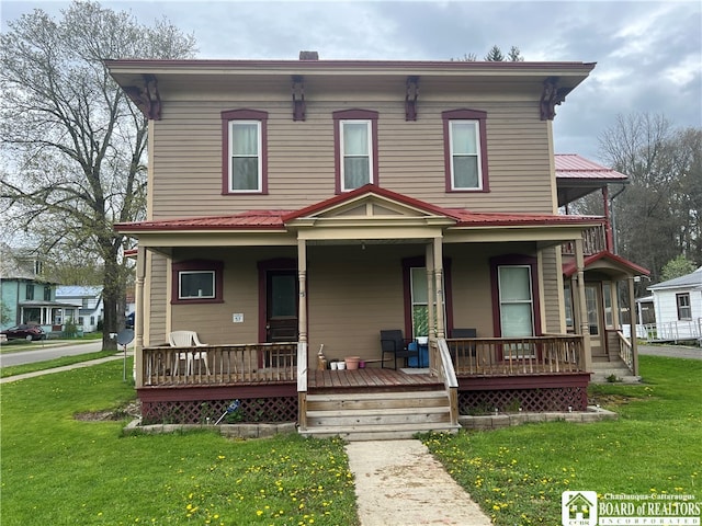 view of front facade featuring covered porch and a front lawn