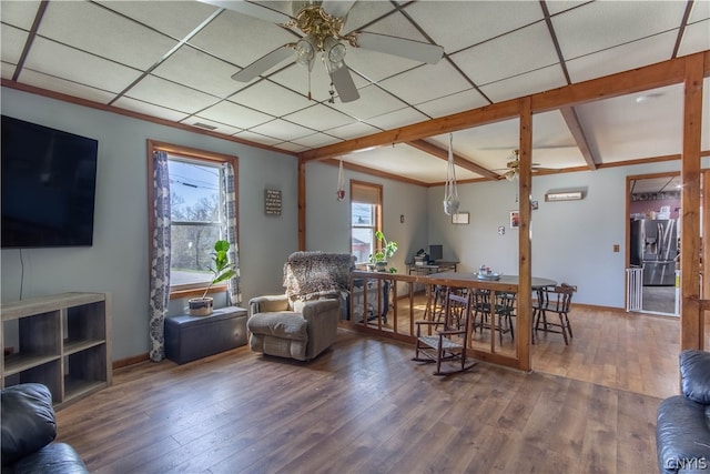 living room featuring ceiling fan, a paneled ceiling, and hardwood / wood-style flooring