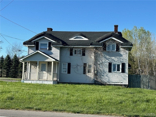 view of front of house featuring covered porch and a front lawn