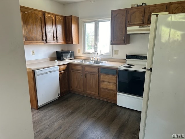 kitchen with white appliances, dark hardwood / wood-style flooring, and sink