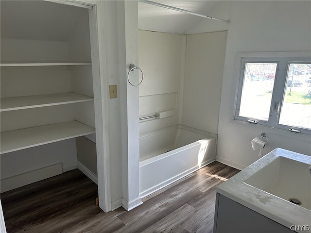 bathroom with wood-type flooring, bathtub / shower combination, and vanity