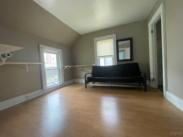 unfurnished room featuring hardwood / wood-style floors and vaulted ceiling