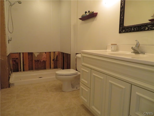 bathroom featuring a shower, vanity, toilet, and tile flooring