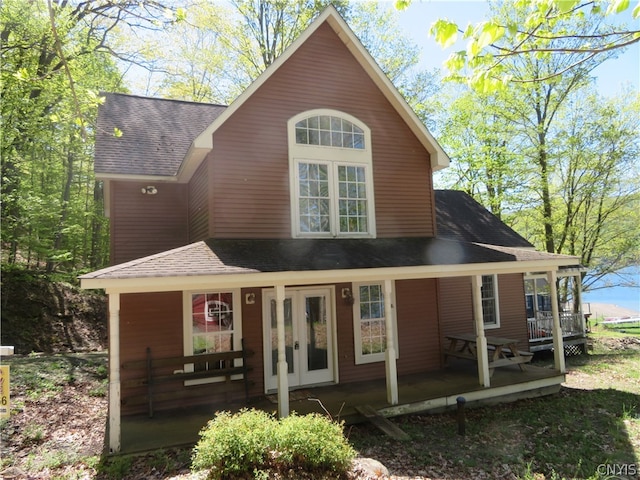 rear view of property featuring covered porch