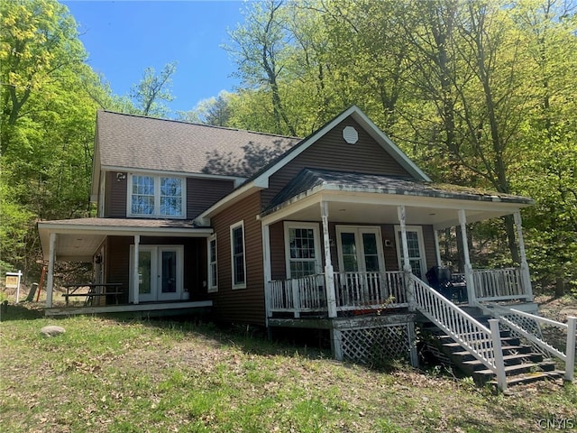 rear view of property featuring covered porch