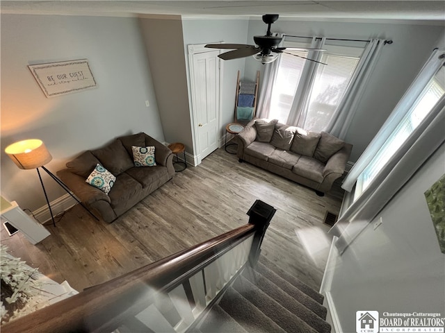 living room featuring ceiling fan and light wood-type flooring