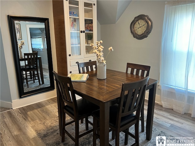 dining area featuring wood-type flooring and plenty of natural light