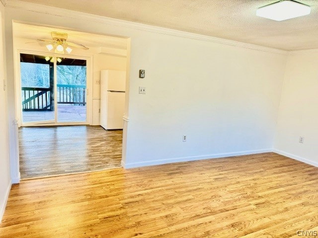 unfurnished room with ornamental molding, light wood-type flooring, a textured ceiling, and ceiling fan