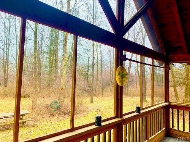 unfurnished sunroom with vaulted ceiling