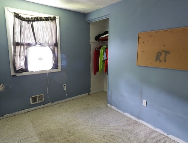 unfurnished bedroom featuring a closet and carpet floors