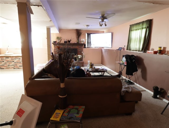 carpeted living room featuring ceiling fan and a fireplace