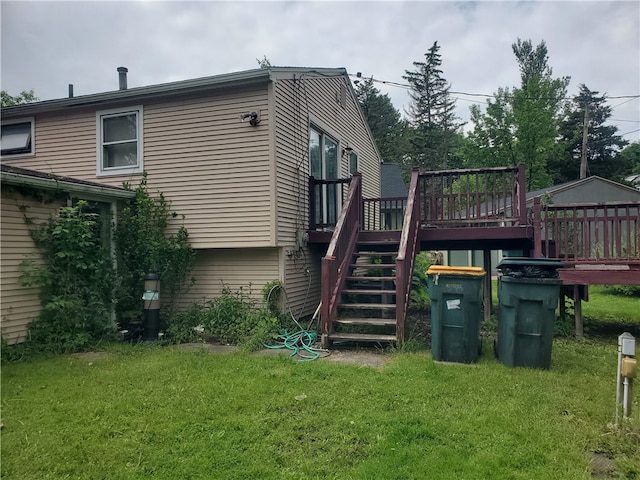 back of house with a deck and a yard