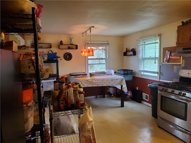 kitchen featuring tile floors, stainless steel range with gas stovetop, and premium range hood