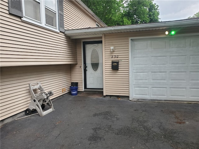 view of exterior entry featuring a garage