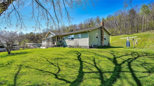 rear view of house featuring a lawn