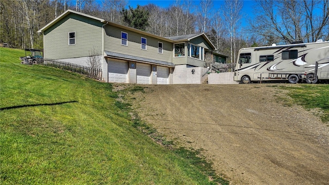 exterior space featuring a garage and a front lawn