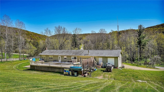 back of house with a yard and a wooden deck