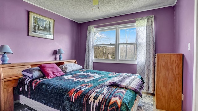 bedroom with ceiling fan, a textured ceiling, and crown molding