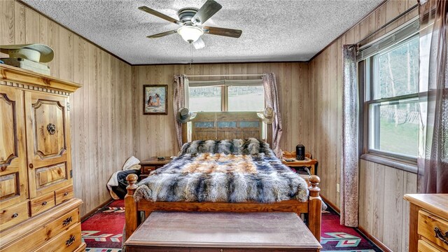 bedroom with carpet flooring, multiple windows, wood walls, and ceiling fan