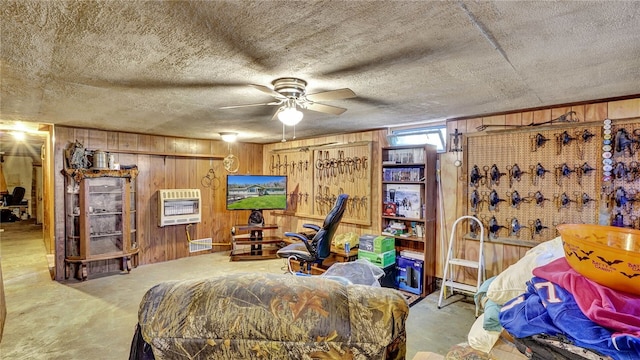 living area featuring wooden walls and ceiling fan