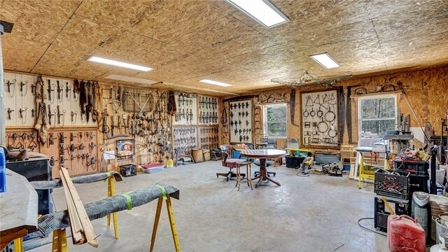 miscellaneous room with a workshop area, plenty of natural light, and concrete floors