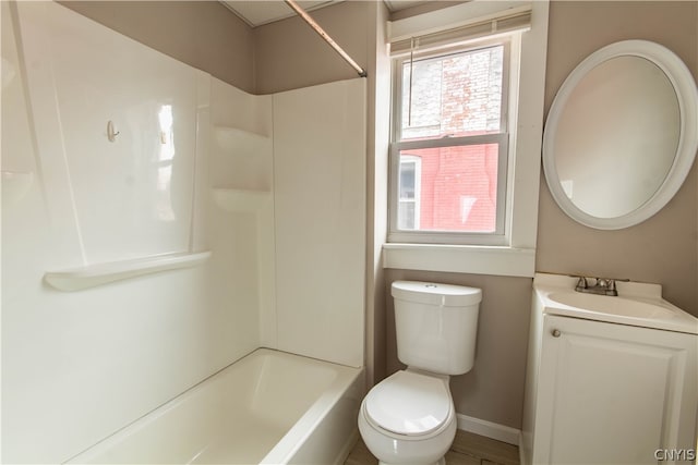 full bathroom featuring a healthy amount of sunlight, toilet, vanity, and bathing tub / shower combination