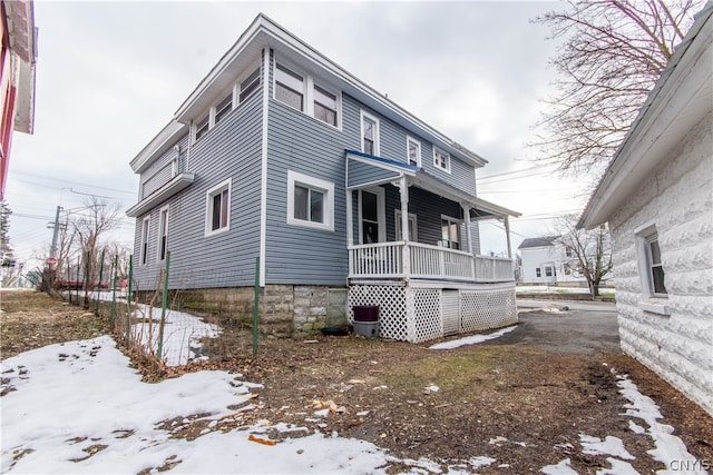 snow covered house with covered porch