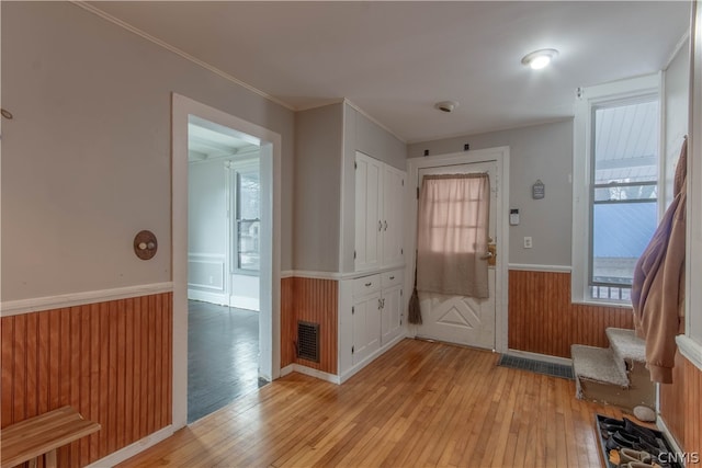 entrance foyer with crown molding and light wood-type flooring