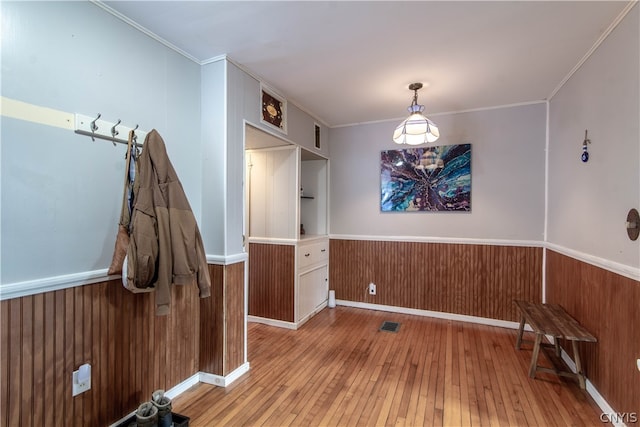 interior space with light hardwood / wood-style floors and crown molding