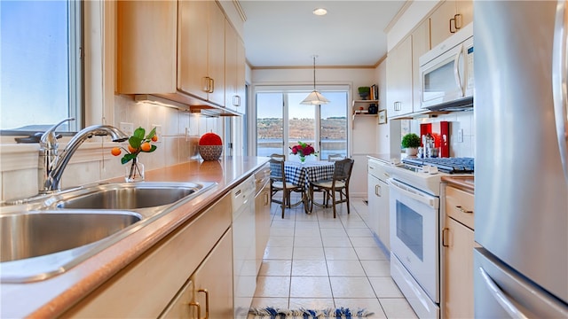 kitchen with sink, decorative light fixtures, white appliances, decorative backsplash, and light tile patterned floors