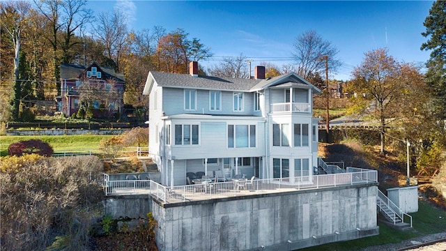 back of property with a balcony