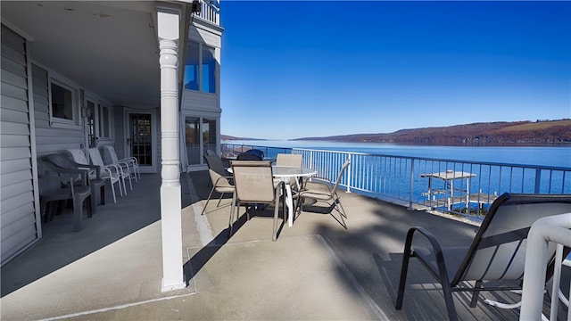 balcony with a water and mountain view