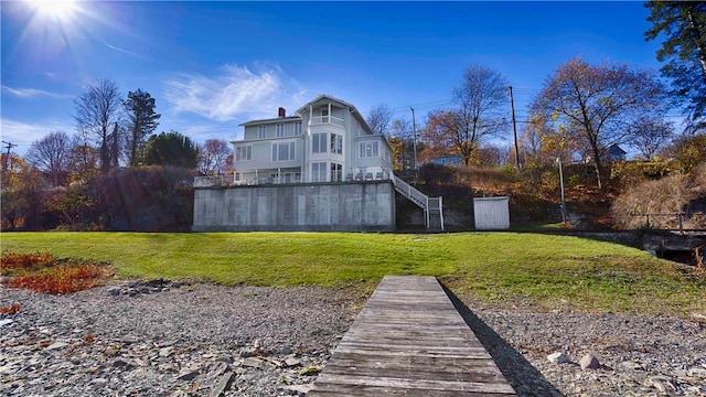 rear view of property with a lawn