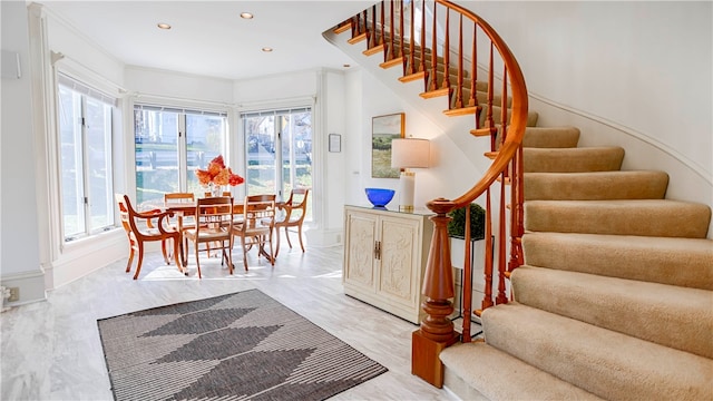 interior space featuring light wood-type flooring and ornamental molding