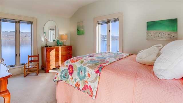 carpeted bedroom with access to exterior, a water view, lofted ceiling, and multiple windows