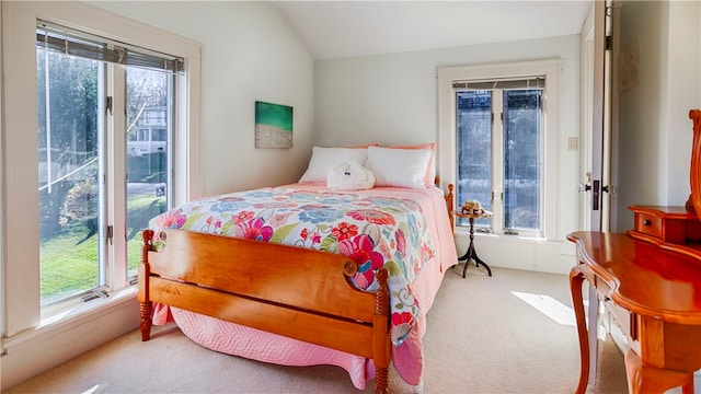 carpeted bedroom featuring multiple windows and vaulted ceiling